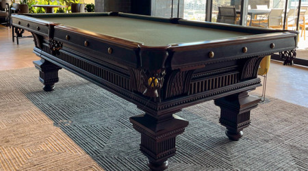 The corner pocket view of a fully restored antique The Jewel pool table
