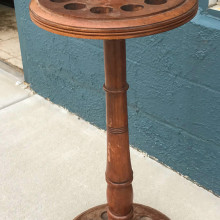 An antique wooden round European 12 cue rack